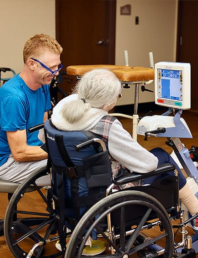 Staff assisting a resident in a therapy session