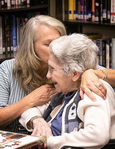 A caregiver sharing a joyful moment with a resident