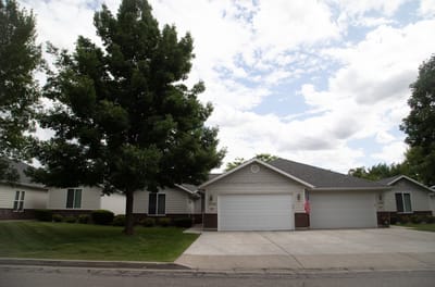 Exterior view of a residential-style facility with landscaped lawn