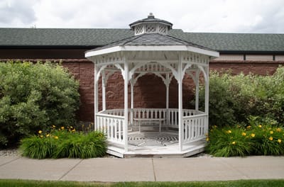 Gazebo surrounded by flowers in a landscaped area