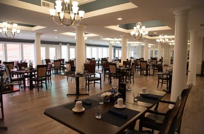 Bright dining room with tables set for meals