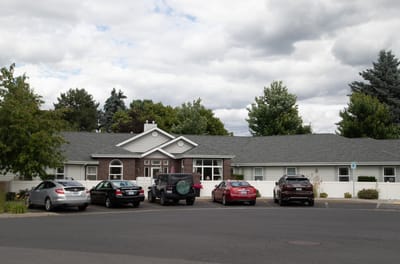 Building exterior of South Hill Village with parked cars
