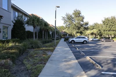 Pathway leading to the facility with parked vehicles