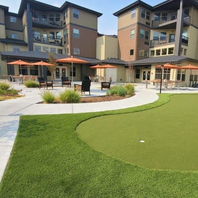 Outdoor patio area with seating and putting green