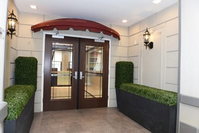 Entrance area with double doors and greenery