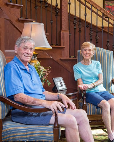 Two residents enjoying conversation in a cozy sitting area