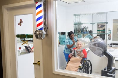 Resident enjoying a hair salon service in the facility