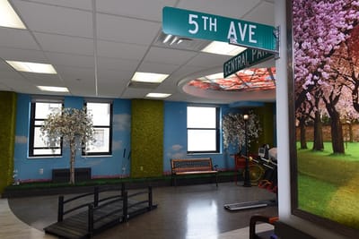 Interior view of a common area with greenery and street sign