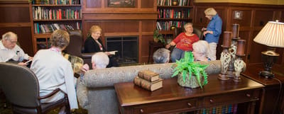 Residents engaging in conversation in a cozy common area