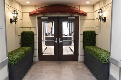 Entrance with double doors and decorative planters