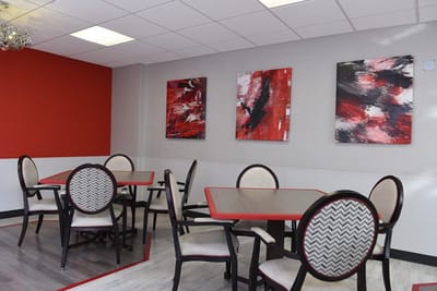 Bright dining area with abstract art on the walls