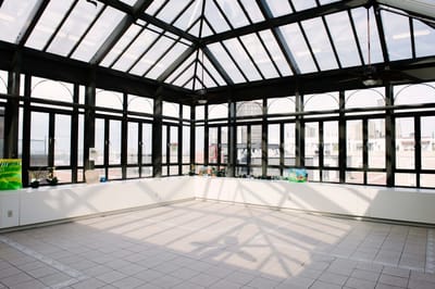 Bright sunroom with large windows and tile floor