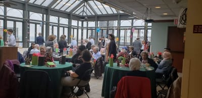 Residents enjoying a lively gathering in a sunlit common area