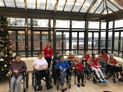 Residents and staff celebrating during a holiday event.