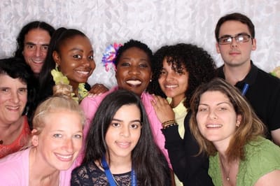 Group of smiling staff and residents posing together