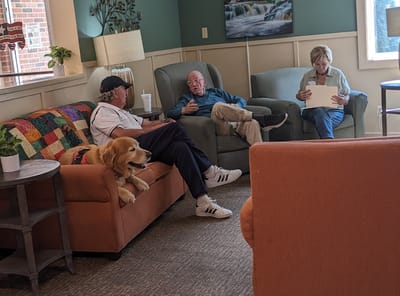 Residents and a dog in a cozy common area