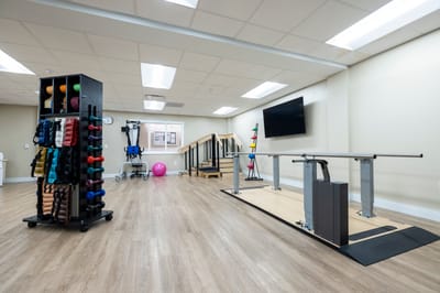 Rehabilitation gym with exercise equipment and therapy bars