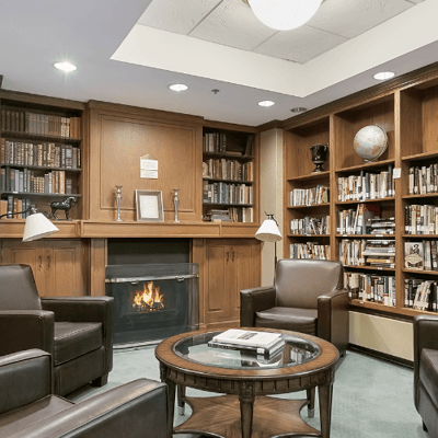 Cozy reading nook with bookshelves and a fireplace