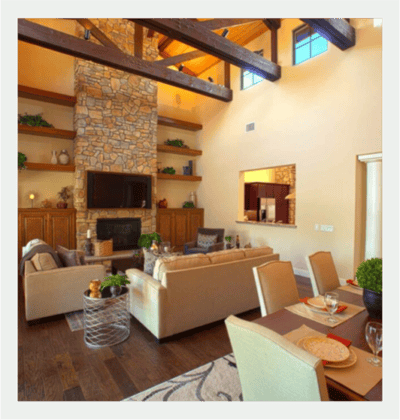 Bright common area with stone fireplace and seating