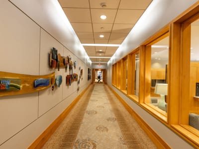 Brightly lit hallway with artwork on the walls