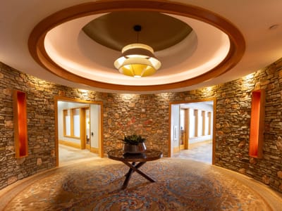 Brightly lit interior entrance with stone walls