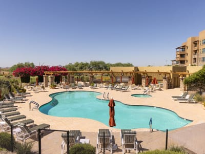 Pool area with lounge chairs and umbrellas