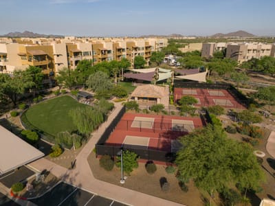 Aerial view of outdoor tennis courts and landscaped area