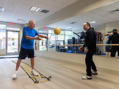 Acacia Health Center at Sagewood, Nursing Home in Phoenix, AZ — Two men exercising with a medicine ball in a gym