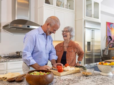 Acacia Health Center at Sagewood, Nursing Home in Phoenix, AZ — Couple preparing food together in a modern kitchen