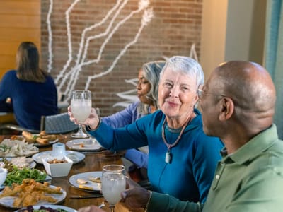 Residents enjoying a meal and drinks at the dining area