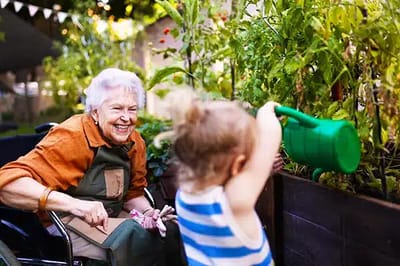 An elderly woman gardening with a young child