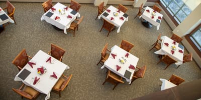 Dining area with elegantly set tables and decor