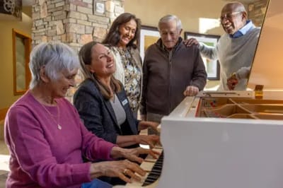 Acacia Health Center at Sagewood, Nursing Home in Phoenix, AZ — Residents gathered around a pianist in a cozy lounge