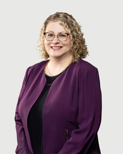 Acacia Health Center at Sagewood, Nursing Home in Phoenix, AZ — Professional portrait of a smiling woman in a purple blazer