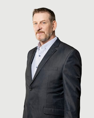 Acacia Health Center at Sagewood, Nursing Home in Phoenix, AZ — Professional man in formal attire against a plain background