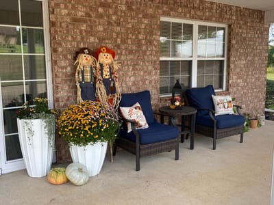 Cozy outdoor seating area with autumn decorations