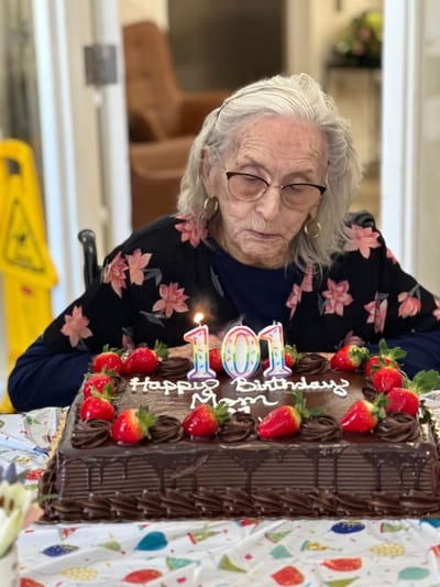 Resident celebrating 101st birthday with cake