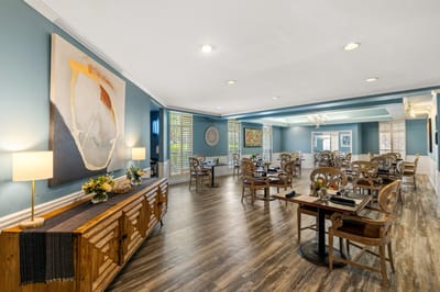 Bright dining room with wooden furniture and artwork