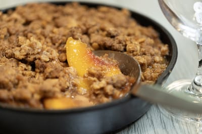Close-up of a freshly baked peach crumble dessert