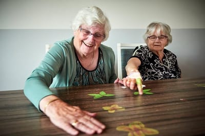 Two senior women enjoying an arts and crafts activity