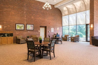 A common area with seating and large windows.