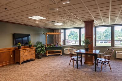 Bright common area with dining and game tables