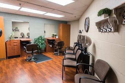 Hair salon area with styling chairs and mirrors