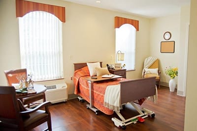 Cozy private room with a bed and chairs
