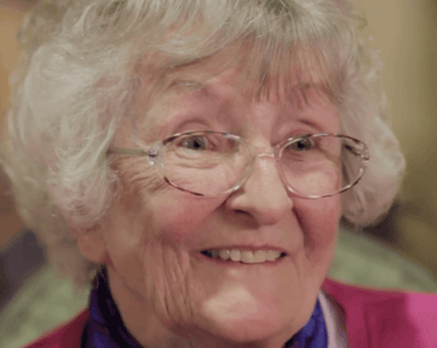 Close-up of a smiling senior woman with glasses