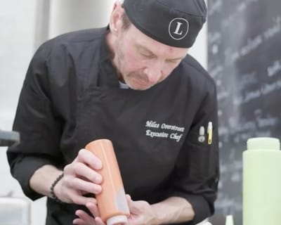 A chef preparing food in a kitchen setting