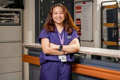 Staff member smiling at the reception desk