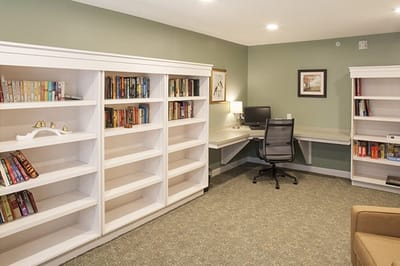 Bright interior room with bookshelves and a desk