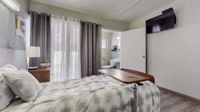 A cozy resident room with a bed and amenities