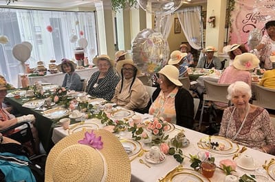 Residents enjoying a festive tea party with hats